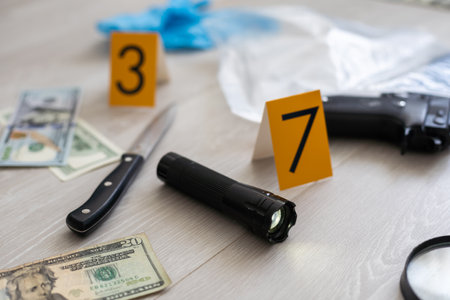 Crime scene investigation, Pistol and bullet shell with blood stain against the crime marker on the ground.の写真素材