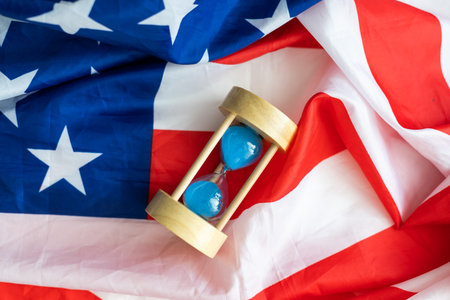 USA red white and blue flag with hour glass showing time is running out for democracy freedom and...