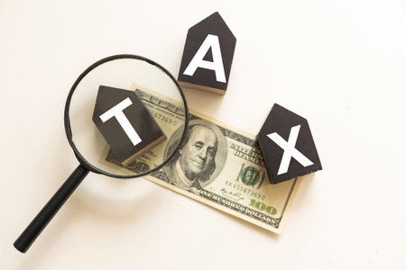 Tax or vat word on wooden cube on white board background. Business financial concept.の写真素材