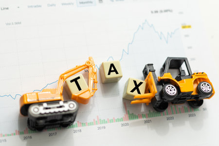 Toy excavator rakes dollars. taxの写真素材