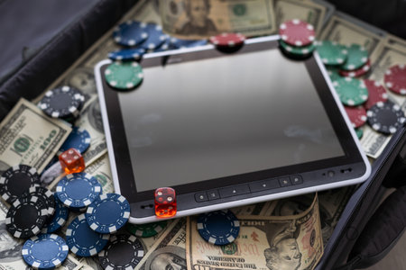 Money, balls and tablet computer on color background. Concept of sports betの写真素材
