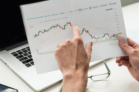 Black Businessman Holding Smartphone and Checking Stock and Cryptocurrency Market in Office....