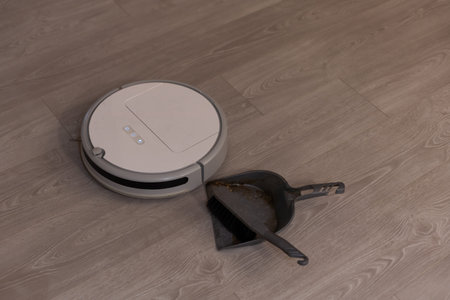 robotic vacuum cleaner on laminate wood floor smart cleaning technologyの写真素材