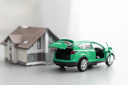 car and house model for sale with money, key on background, house for sale concept, closeup.の写真素材