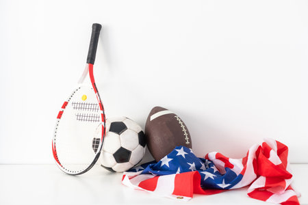 Various sport equipment for baseball, football, soccer and fishing on vintage wooden USA flagの写真素材