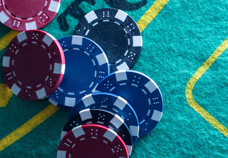 Casino chips stacking on a green felt.