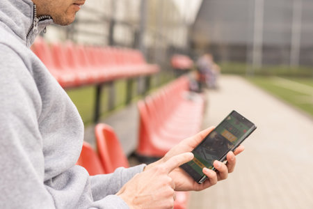 Man using online sports betting services on phone