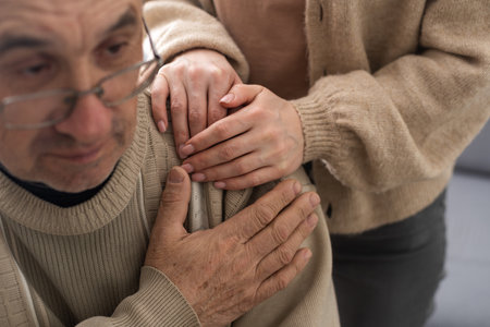 Senior couple, happy and laughing in their home with love, care and support for retirement lifestyle. Commitment of a funny man and woman in a marriage with trust and security on a living room couch.の写真素材