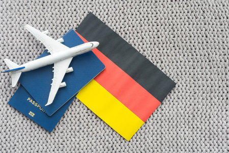 Flag of Germany with passport and toy airplane. Flight travel concept.の写真素材