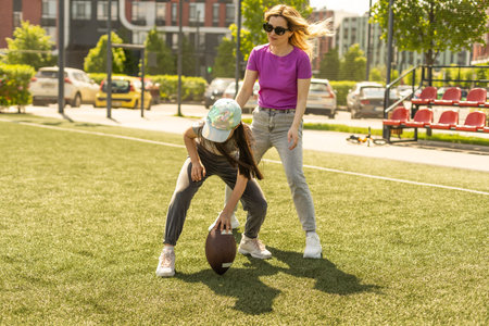 mother and daughter playing american football