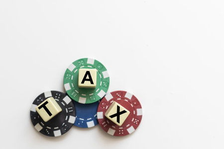 TAX wooden cubes on the chart background , look through a magnifier