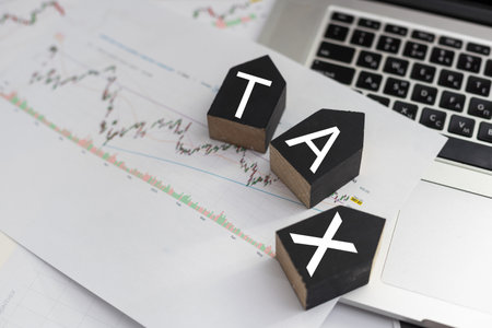 Tax Concept.Word tax and stacked coins put on desksの写真素材