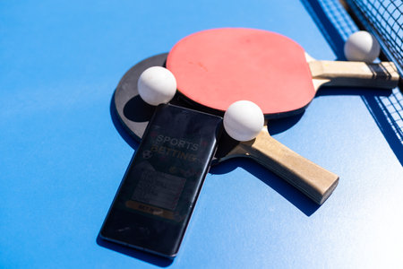 table tennis racket, smartphone on the tableの写真素材