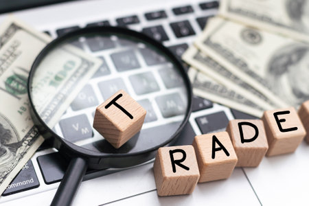 On the laptop, on wooden cubes near the pen, the word TRADE is written.の写真素材
