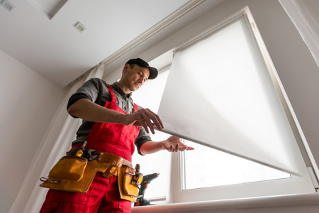 master with a screwdriver sets fittings on the windowの写真素材