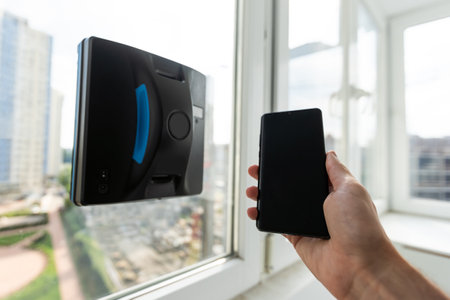 Domestic vacuum cleaner robot washing glass windowの写真素材