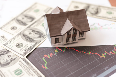 House model with real estate agent and customer discussing for contract to buy house, insurance or...