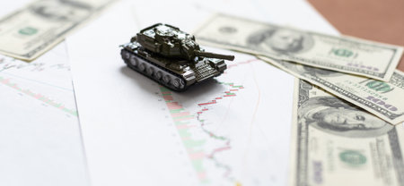 a toy tank, dollars and a tablet