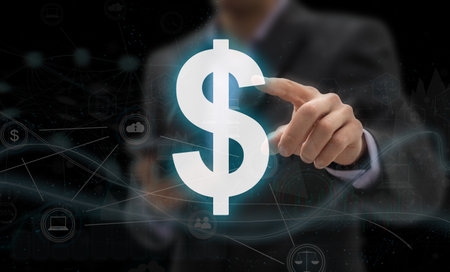 Hand pointing at creative glowing polygonal dollar sign on blurry office interior background. Online banking and digital transformation conceptの写真素材