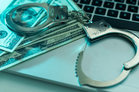 The handcuffs are on hundred-dollar bills. Power and bribery. Criminal ransom. Criminal earnings....