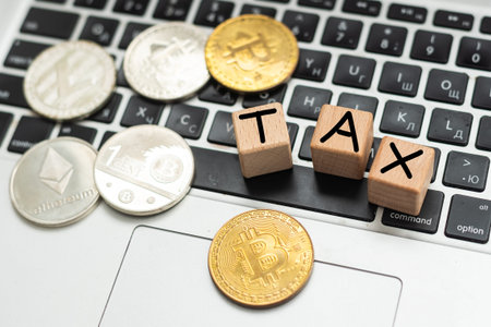 Bitcoin and next to wooden with TAX letters. Bitcoin taxation concept
