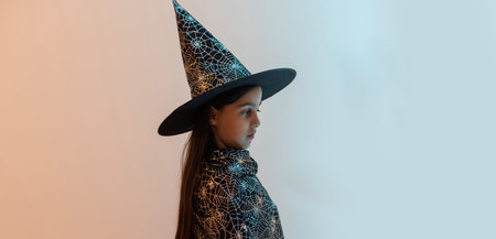 halloween child in witch hat look like wizard school pupil, happy halloween holiday.