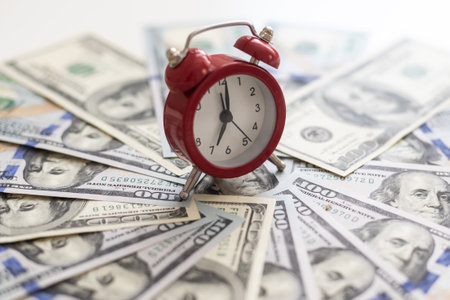 Money and time come together in a vertical format for various conceptual themes.の写真素材