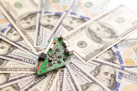Circuit board on banknotes. Increasing the cost of electronicsの写真素材