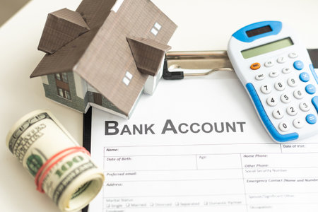 Toy house and calculator on table close-upの写真素材