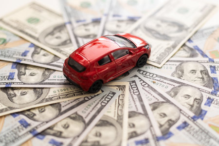 Toy car and money over white. Rent, buy or insurance car concept