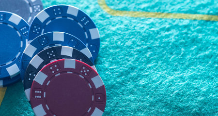 Stack of casino chips or tokens on a numbered roulette board in payment of a bet in a gambling game...