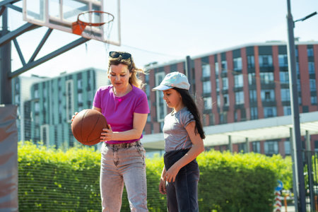 Mother and little daughter after basketball. Great job honey.の写真素材