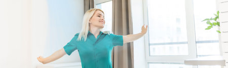 Women enjoy the coolness while standing in front of the air conditioner