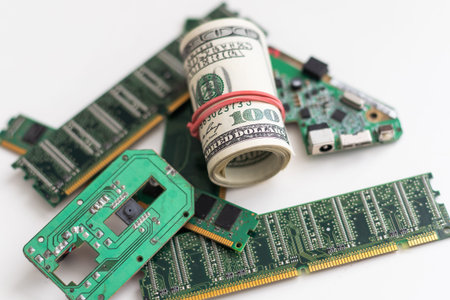 Computer CPU and memory chips on US dollar banknotes background. The high cost of microelectronics...