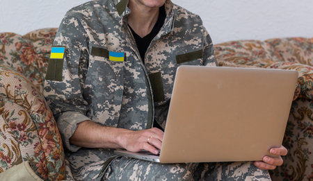 Ukrainian military man with a laptopの写真素材