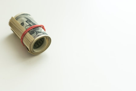 oll of dollars bills isolated on a white backgroundの写真素材