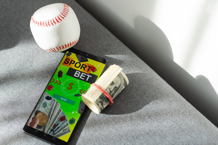 Smartphone with baseball ball and field on the screen. Sports theme and applications. Isolated on white background.の写真素材