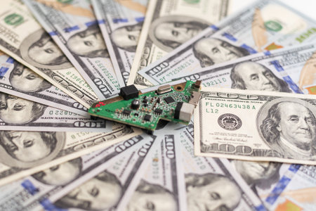 Electronic circuits, microchips, substrates for technology with dollars lying nearby. Electronics cost conceptの写真素材
