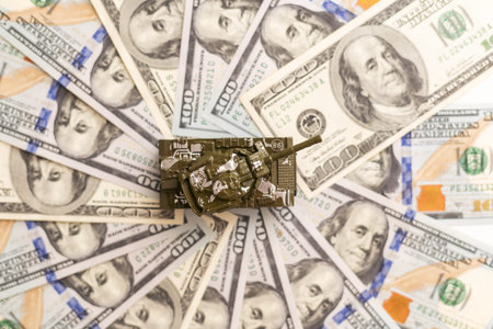 Tank on dollar banknotes. The concept of war costs, military spending, economic crisis