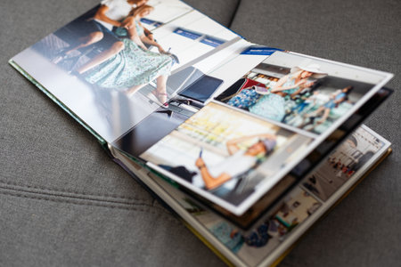 close up. photo book binding. storing photos from a photo session in a photobook (paper with a grainy structure) the result of the photographer and designer.の写真素材