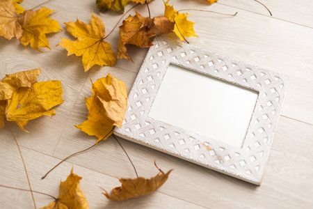 Autumn composition. Photo frame mockup with dried leaves flowers on white background. Autumn, fall, halloween concept. Flat lay, top view, copy space, squareの写真素材