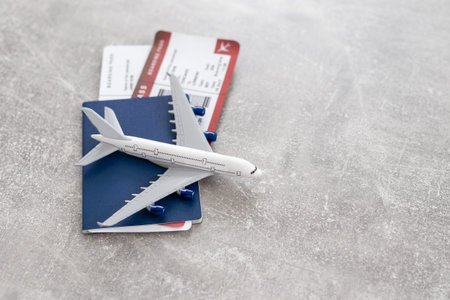 Top view of Travel concept With passport, airplane model.