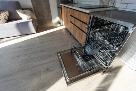 Open clean empty dishwasher in kitchen, closeupの写真素材