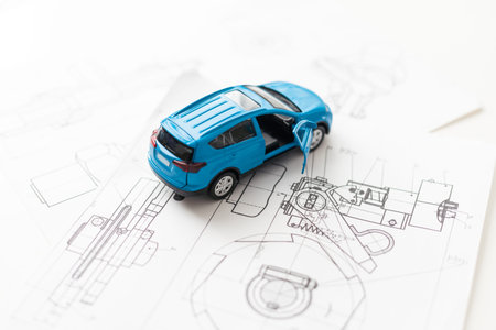 small car model and blueprint sheets