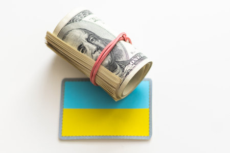 100 dollar banknote and Ukrainian national flag for design purposeの写真素材
