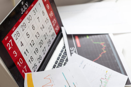 Preparing report. Blue graphs and charts. Business reports and pile of documents on gray reflection background.の写真素材