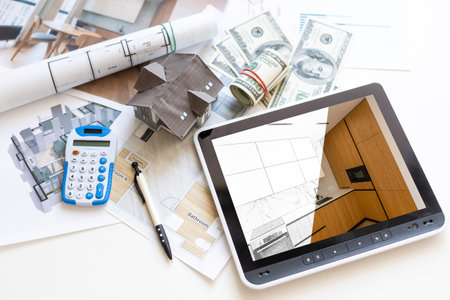 House model on architect drawing with laptop and calculatorの写真素材