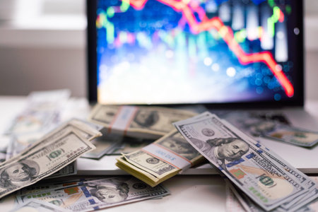 Different dollar bills and business graph in the background. Natural photo.