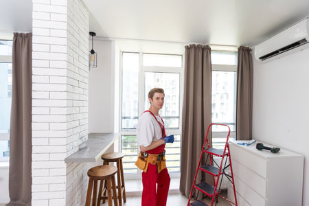 technician service checking and repairing air conditioner indoorsの写真素材