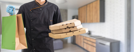 Courier holding paper bags with food, space for text. Delivery serviceの写真素材